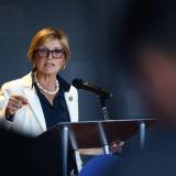 Congresswoman Lee speaking at a podium