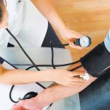 Physician taking pressure of patient. Getty Images