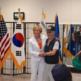 Congresswoman Lee with shaking hands with veteran