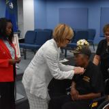 Rep. Susie Lee pinning a Vietnam Veteran