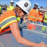 Congresswoman Susie Lee signing a solar panel