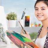 Smiling artist with paintbrush