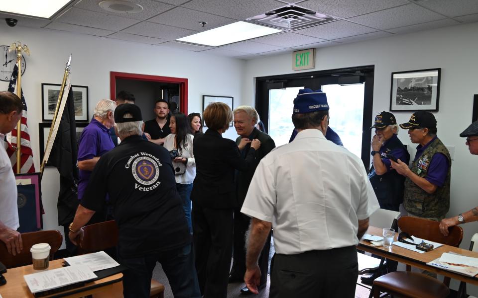 Congresswoman Lee pinning a Vietnam veteran