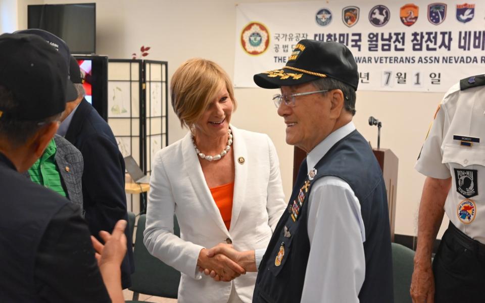 Congresswoman Lee shaking hands with veteran