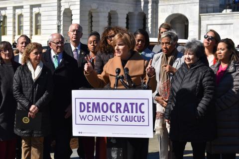 Congresswoman Lee speaking at podium