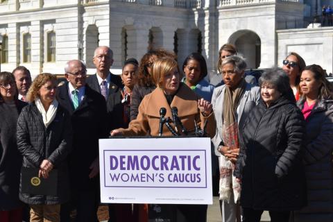 Congresswoman Lee speaking at podium