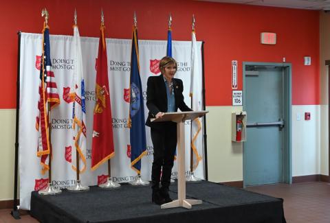 Congresswoman Lee speaking at podium