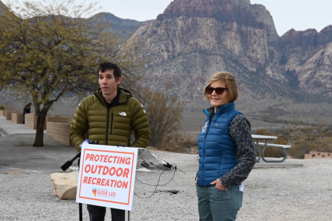 Congresswoman Lee and Alex Honnold at the podium