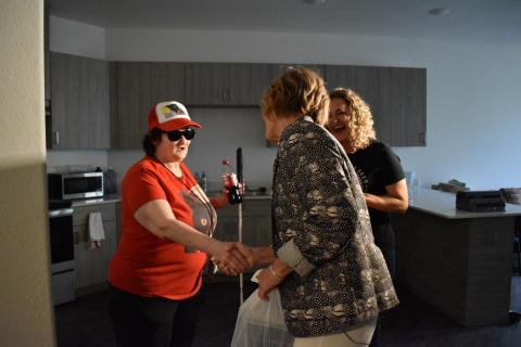 Rep. Susie Lee shakes hands with Meals on Wheels recipient Mae Courson