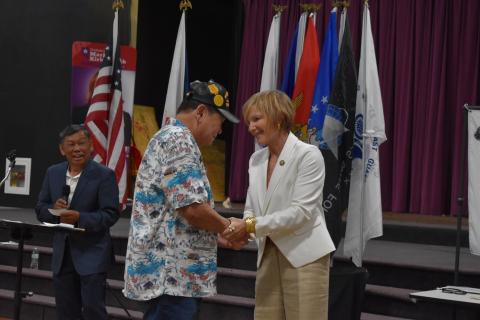 Rep. Susie Lee shakes hands with a Vietnam Veteran
