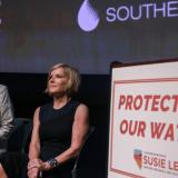 Senator Cortez Masto and Congresswoman Susie Lee sit by sign that says "protecting our water"