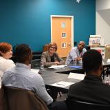 Congresswoman Lee sitting at roundtable