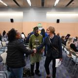 Congresswoman Lee shaking hands with participants