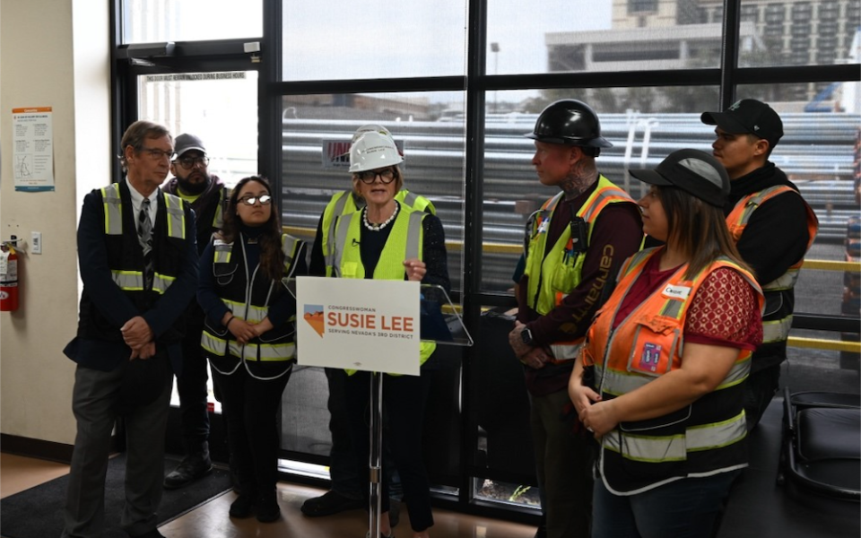 Congresswoman Lee at podium with Unimacts workers