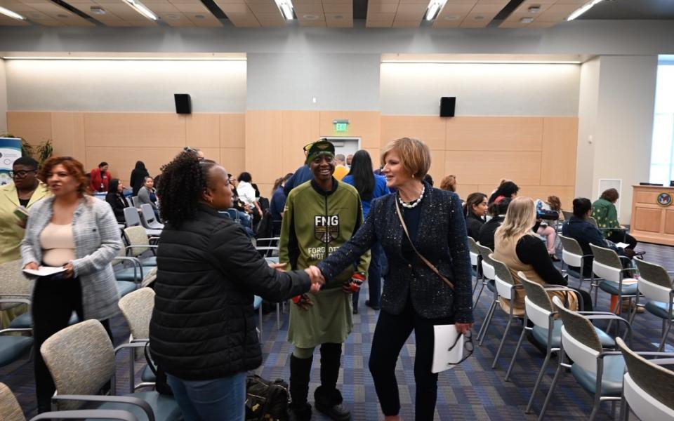 Congresswoman Lee shaking hands with participants